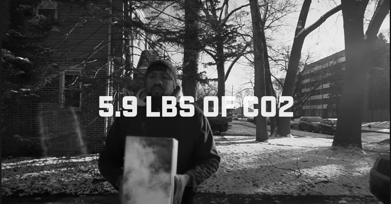 Man holding a glass box containing 5.9 pounds of C O 2